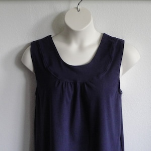 Navy blue sleeveless adaptive post surgery shirt that fastens at the shoulder with hook/loop fasteners. Step into the shirt and pull it up under sling.  Perfect for shoulder surgery, mastectomy, slings or anything that limits arm movement.