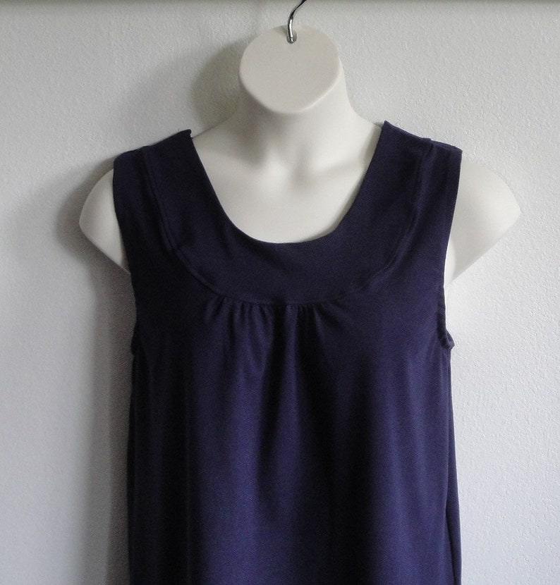 Navy blue sleeveless adaptive post surgery shirt that fastens at the shoulder with hook/loop fasteners. Step into the shirt and pull it up under sling.  Perfect for shoulder surgery, mastectomy, slings or anything that limits arm movement.