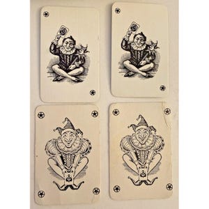 May include: Four vintage playing cards featuring a black and white illustration of a jester. Two cards show the jester holding a card and a small doll. The other two cards depict a seated jester with a large collar and a hat.