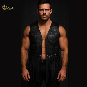 May include: Black leather vest featuring skull and bat motifs. The sleeveless vest has a V-neck, fringe detailing, and small silver studs. It fastens with buttons. The vest is a dark, gothic style.