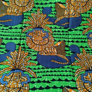 May include: Vibrant fabric featuring a repeating pattern of stylized seashell-like shapes in orange and yellow, set against a blue and brown background. The design is on a bright green background with black wave-like lines.