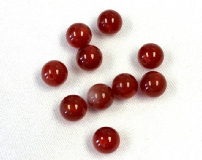 Half drilled natural carnelian beads, sold by the pair