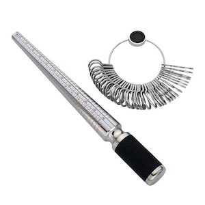 May include: A silver ring sizer with a black handle and a set of 20 silver ring sizing gauges. The ring sizer has a measurement scale in inches.