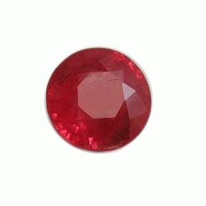 May include: A round, faceted ruby gemstone. The gem is a deep red color and appears to be cut with multiple facets to reflect light. The gemstone is set against a plain white background.