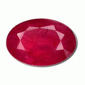 May include: A faceted, oval-cut ruby gemstone. The gem is a deep red colour with internal reflections. The cut reveals multiple facets, enhancing its brilliance. The ruby is set against a white background, highlighting its colour and shape.