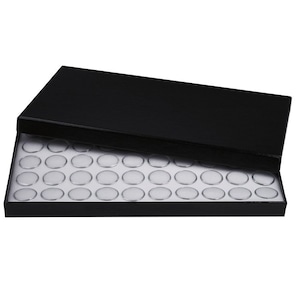 May include: Black coin storage box with a white foam insert containing 100 round compartments for storing coins.