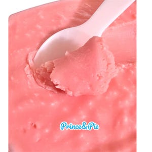 May include: Close-up of a container of pink dessert with a white spoon. The dessert has a smooth, textured appearance. The text "Prince & Pie" is in a blue and white font at the bottom of the image.