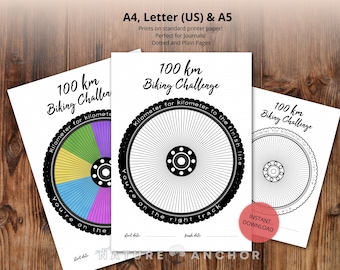 May include: Three white paper printables with a bicycle wheel design for a 100 km biking challenge. The printables include the text "100 km Biking Challenge" and "You're on the right track". One wheel is colored, and the others are black and white.