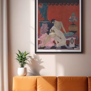 May include: Framed art print featuring a classical-style illustration of nude figures in a vibrant red and black setting. The artwork includes a decorative border and a small statue. The print is displayed above an orange sofa.