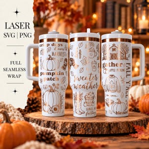 May include: Three white tumblers with handles featuring a copper-colored autumn-themed pattern. The designs include pumpkins, sweaters, barns, leaves, and text such as "sweater weather," "pumpkin patch," "gather," and "fall y'all" in a seamless wrap.