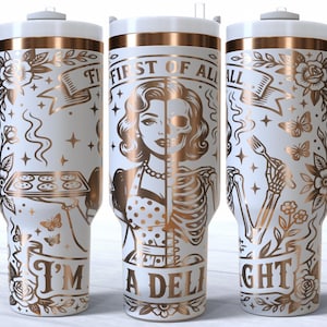 May include: White insulated tumbler with a handle, featuring gold-colored illustrations and text. The design includes a woman's face, a skeleton, butterflies, and the phrases "First of All" and "I'm a Delight."