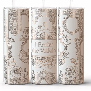 May include: White tumbler with a rose gold design and the text "I Prefer the Villain." The design includes roses, ornate frames, and architectural details. The tumbler has a straw and is designed to keep drinks cold.