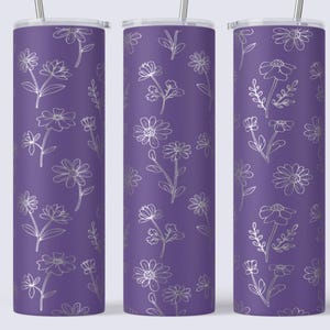 May include: Three purple insulated tumblers with a silver floral pattern. The design features various flowers and leaves in a delicate, line-art style. Each tumbler has a silver straw and a white lid.