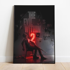 May include: A framed poster for "The Evil Within 2" features a seated figure with a rifle, illuminated by red light. The title and the number "2" are prominently displayed, with a dark, dramatic background.