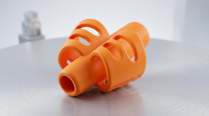 May include: Bright orange ergonomic pen grip with a cylindrical shape and multiple finger holes. The product is labeled "ERGOGRIP PRO 3D" and is designed to improve writing comfort and control. The grip is made of a smooth, matte material.