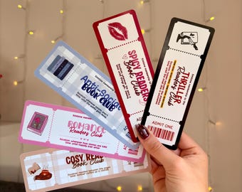 May include: A collection of colorful bookmarks with various club themes. The bookmarks include "Spicy Readers Book Club," "Anti-Social Book Club," "Thriller Readers Club," "Romance Readers Club," and "Cosy Read Book Club." Each bookmark has a unique design and text.