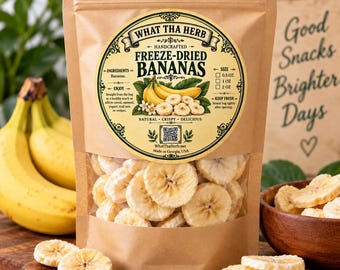 May include: A brown kraft paper pouch containing freeze-dried banana slices. The label features the text WHAT THA HERB, FREEZE-DRIED BANANAS, and an illustration of bananas. The pouch has a clear window showing the light-colored, round fruit slices.