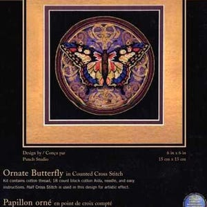 May include: The Gold Collection Petites Ornate Butterfly counted cross stitch kit features a butterfly with blue, yellow, and red wings centred in a circular purple and gold frame. The packaging includes the text 6 in x 6 in and 15 cm x 15 cm.