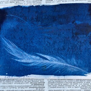 May include: A cyan blue background with a white feather in the center. The feather is slightly curved and has a delicate texture. The background has a mottled, textured appearance.