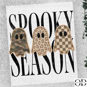 May include: Three ghost-shaped patches featuring different patterns: a green and brown camouflage print, a tan and brown leopard print, and a tan and brown checkerboard print. Each ghost has two black oval eyes and is set against a white background with the black text SPOOKY SEASON.