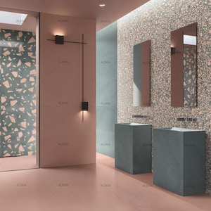 May include: A modern bathroom interior featuring a color palette of pink, teal, and gray. The space includes two gray pedestal sinks, rectangular mirrors, and a decorative wall light fixture. The walls have a terrazzo-like pattern.