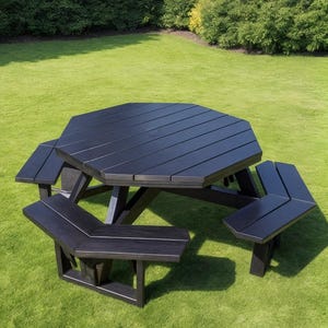 May include: A black octagonal picnic table with attached benches. The table has a slatted top and is set on a green lawn. The benches are angled and provide seating for multiple people. The table is made of a dark material.