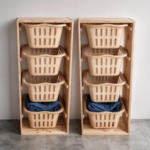 May include: Two wooden storage units, each with four beige plastic baskets. The baskets are stacked within a light-colored wooden frame. Each unit contains a pair of blue jeans in the bottom basket.