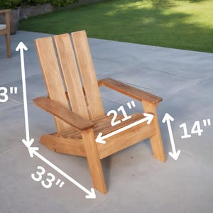 May include: A light brown wooden Adirondack chair with a slatted back and armrests. The chair is 33 inches tall, 21 inches wide, and 33 inches deep. The seat height is 14 inches. The chair is outdoors on a patio.