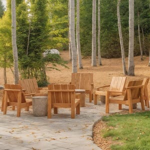 May include: A circular outdoor seating arrangement featuring six wooden armchairs and a small stone side table. The chairs are made of light-colored wood and are arranged on a stone patio, surrounded by trees.