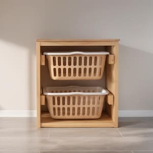 May include: A wooden storage unit with two beige laundry baskets. Each basket has a rectangular shape with a white rim and a grid pattern of vertical slots. The unit is made of light-colored wood.