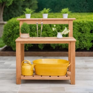 May include: A wooden potting bench with two tiers, holding small potted plants and gardening tools. A yellow watering can and a yellow oval tub sit on the lower shelf. The bench is outdoors with a green hedge background.