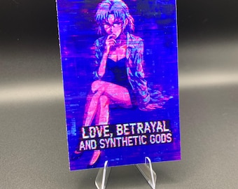May include: A rectangular print featuring a digital illustration of a person in a blazer and dress, with the text "LOVE, BETRAYAL AND SYNTHETIC GODS" in white. The print is displayed on a clear plastic stand.