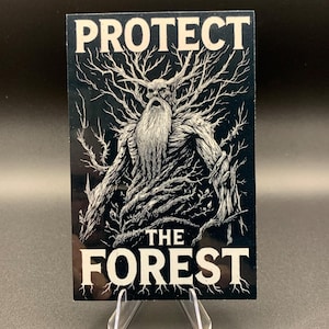 May include: A black and white sticker featuring a detailed illustration of a tree-like figure with the text "PROTECT THE FOREST". The figure has a long beard and branches for hair. The sticker is displayed on a clear stand.