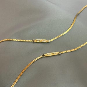 Vintage Monet 30" gold tone chain necklace, flat with side accents