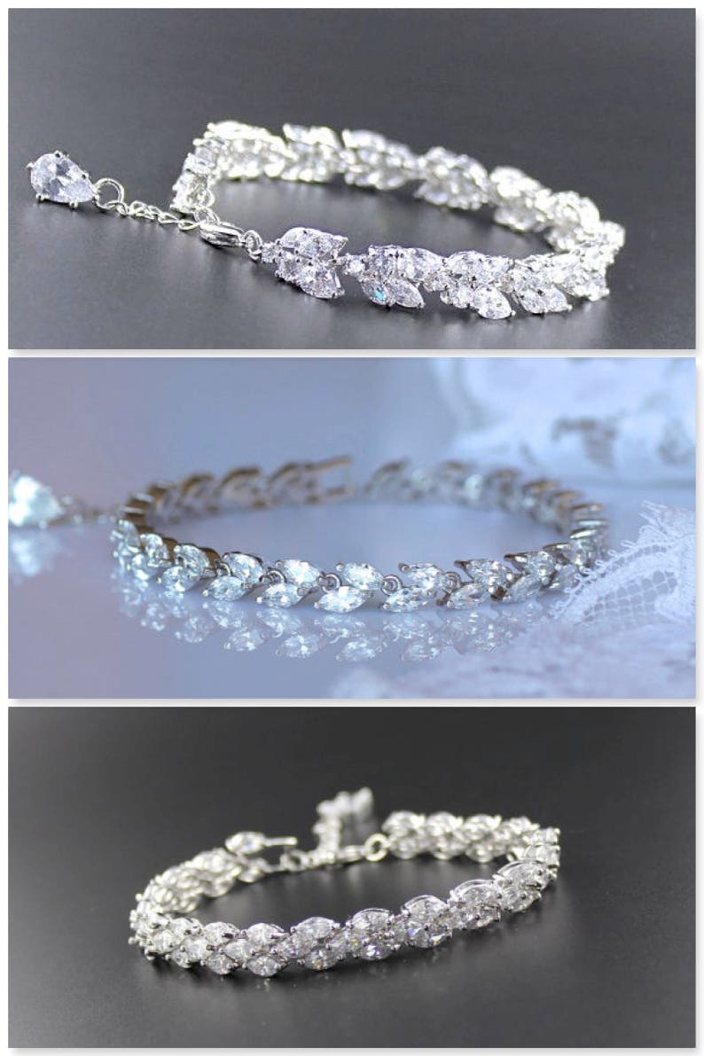 K&ouml;nnte beinhalten: Ein silbernes Armband mit einem zarten Design aus marquisef&ouml;rmigen Steinen, die in einem Blattmotiv eingefasst sind.