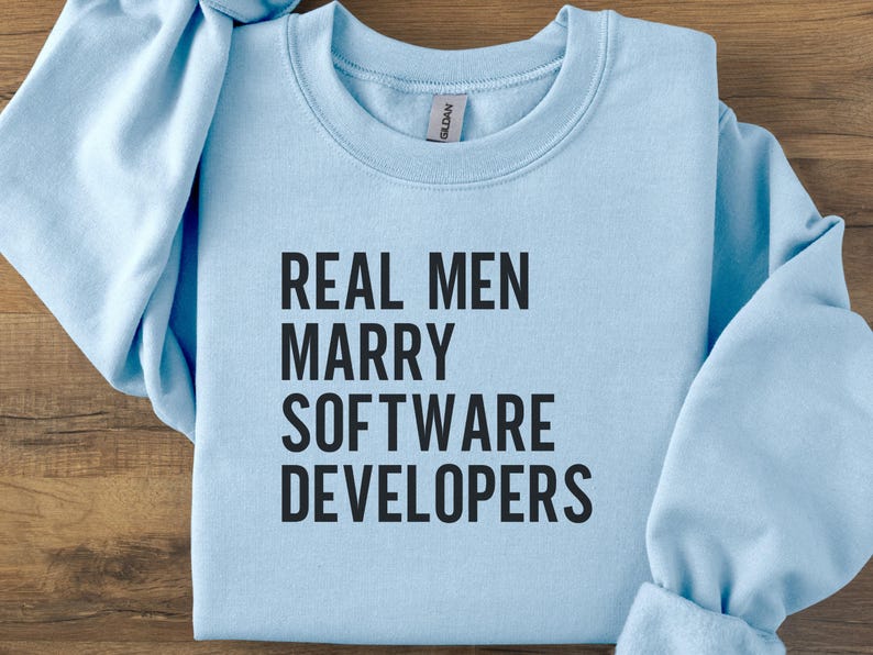 Light blue Gildan sweatshirt with "REAL MEN MARRY SOFTWARE DEVELOPERS" text.