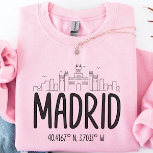 May include: A white ceramic mug with a black handle and the text "But First, Coffee" in a handwritten style. The mug is on a white surface. The mug is 4 inches tall.