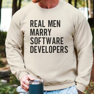 Crewneck sweatshirt with text "REAL MEN MARRY SOFTWARE DEVELOPERS".