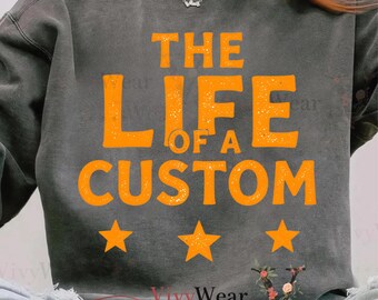 May include: Dark gray sweatshirt with the text "THE LIFE OF A CUSTOM" in orange, along with three orange stars below the text. The sweatshirt has a vintage, worn look.