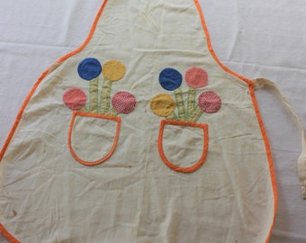 Handmade vintage 1940's or 1930's child's apron, hand stitched and embroidered flower embellishment on the pocket