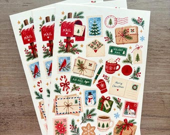 May include: A set of three identical sticker sheets featuring Christmas-themed illustrations including a red mailbox, envelopes, postage stamps, a snowman, a mug of cocoa, a candy cane, a mitten, gifts, and the text Merry Christmas.