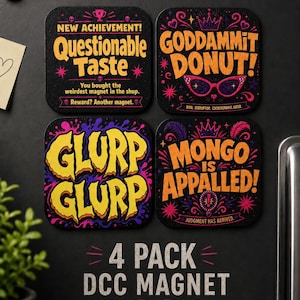May include: Four square magnets with amusing phrases in vibrant colours. The phrases include "Questionable Taste," "Goddammit Donut," "Glurp Glurp," and "Mongo is Appalled!" The magnets are black with decorative elements.