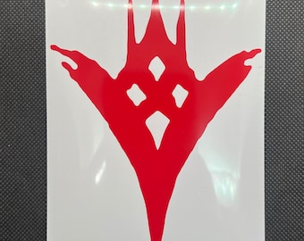 May include: Red vinyl sticker with a symmetrical design. The graphic has a central, downward-pointing element with three upward spikes and three diamond shapes. The sticker is on a white background.