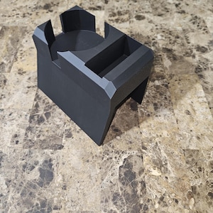 以下が含まれることがあります： 幾何学的なデザインの黒い3Dプリントデスクオーガナイザー。円形のホルダー、長方形のスロット、小さなコンパートメントがあります。オーガナイザーはマットブラックのプラスチック製で、モダンでミニマリストな美しさを持っています。