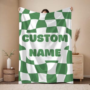 May include: A set of three ceramic mugs with a speckled, matte finish. The mugs are in shades of cream, light brown, and dark brown. Each mug has a simple, minimalist design and a rounded handle. The mugs are stacked on top of each other.