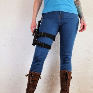 A woman wearing a Jill Valentine thigh holster by Vontoon made from durable polypropylene and strong plastic buckles