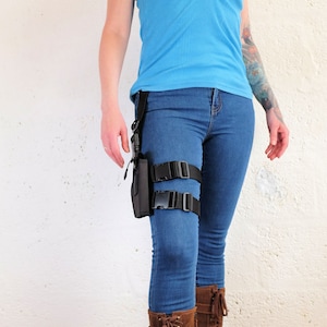 A woman wearing a Jill Valentine thigh holster by Vontoon made from durable polypropylene and strong plastic buckles