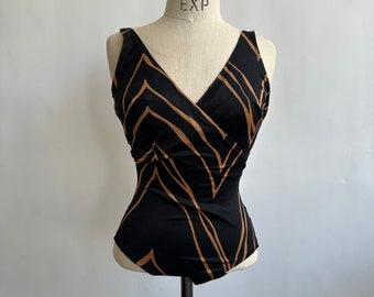 May include: A black swimsuit with a brown geometric pattern. The swimsuit has a V-neck and a sleeveless design.