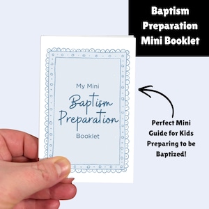 May include: A small booklet titled "My Mini Baptism Preparation Booklet" is held in a hand. The cover has a light blue background with a decorative border and the words "Baptism Preparation" in a script font. The booklet is a guide for kids preparing to be baptized.