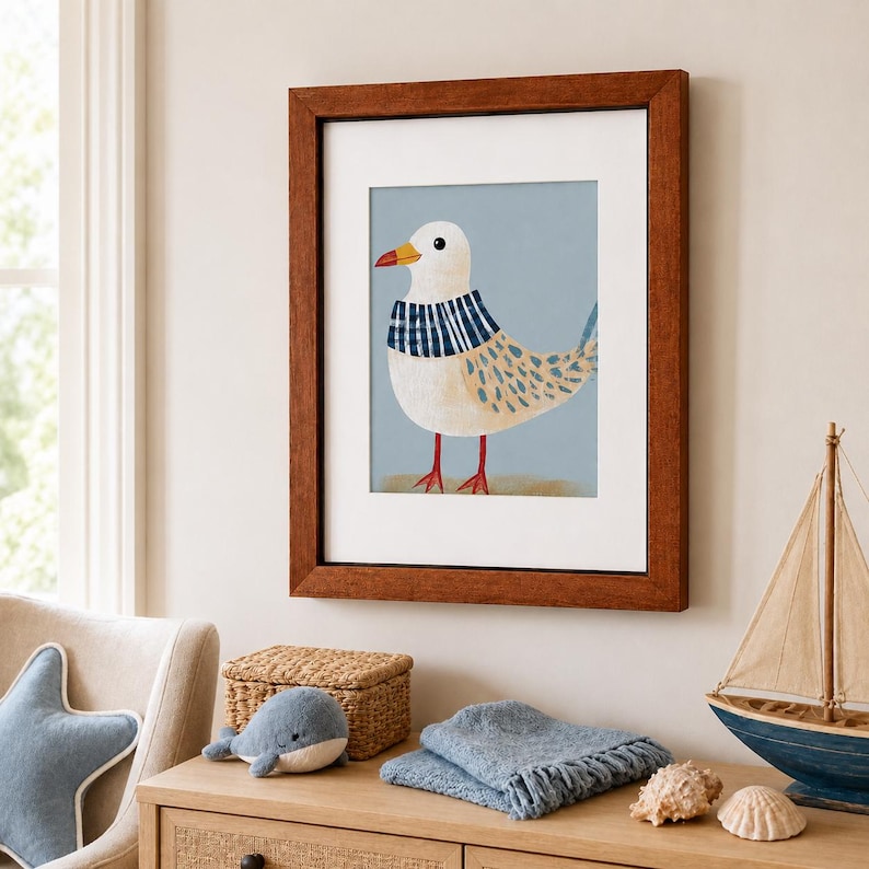 Puede incluir: Una l&aacute;mina de arte enmarcada que presenta una ilustraci&oacute;n estilizada de una gaviota blanca con una bufanda de rayas azules y blancas alrededor del cuello, sobre un fondo azul claro, en un marco de madera marr&oacute;n oscuro con paspart&uacute; blanco.